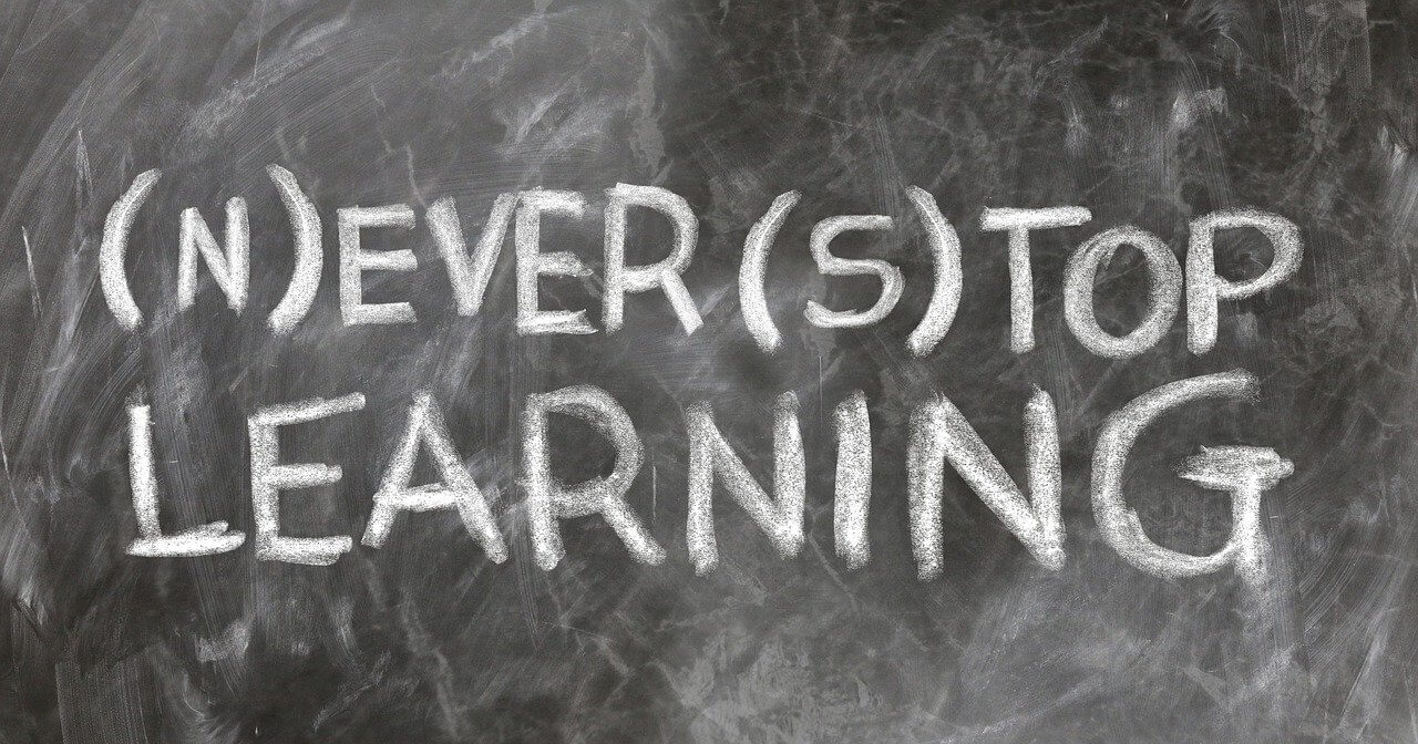 Never stop learning written in white chalk on blackboard