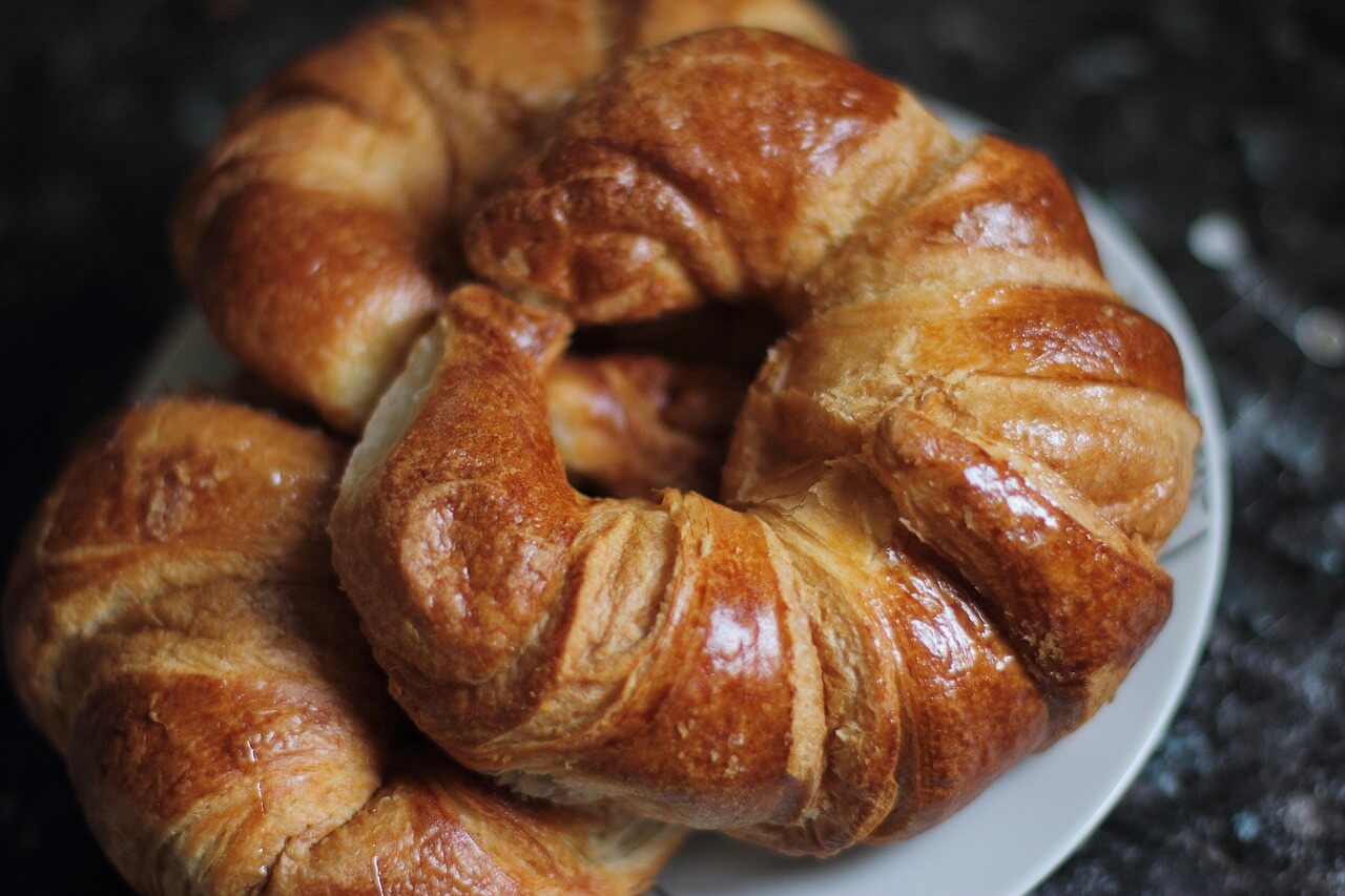 Three croissants on a white plate