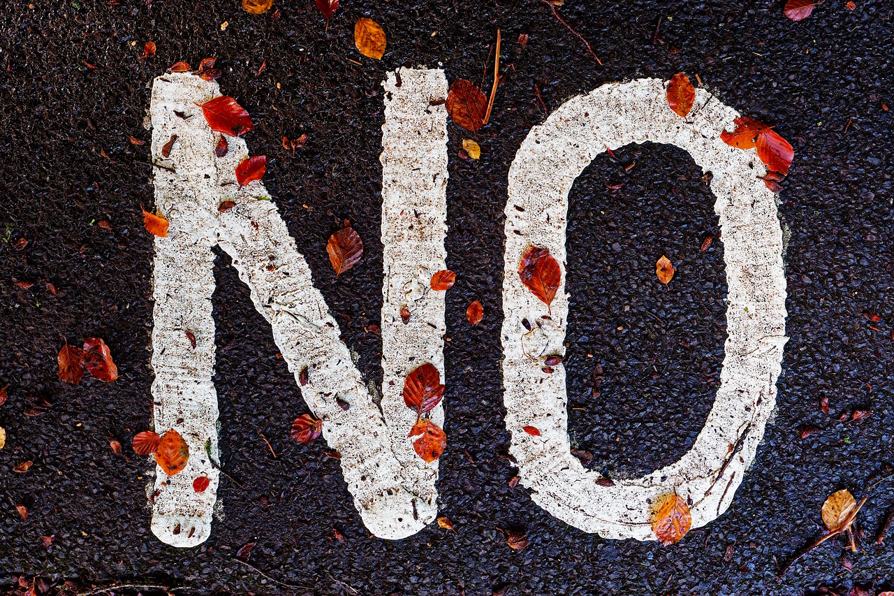 "No" written in white paint on a street