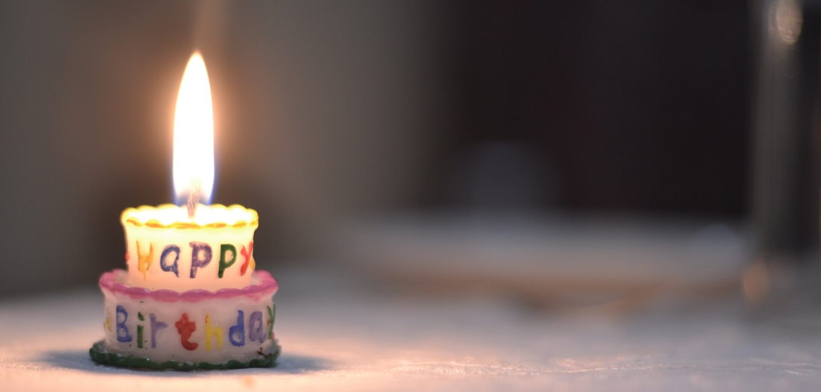 A small birthday cake with a single candle